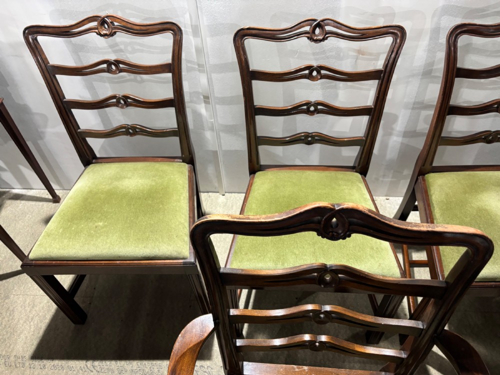 A set of six dark mahogany ladderback dining chairs, including two carvers and four side chairs, featuring serpentine carved splats and green velvet seats. View III