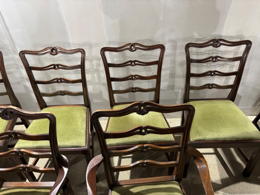 A set of six dark mahogany ladderback dining chairs, including two carvers and four side chairs, featuring serpentine carved splats and green velvet seats. View IV
