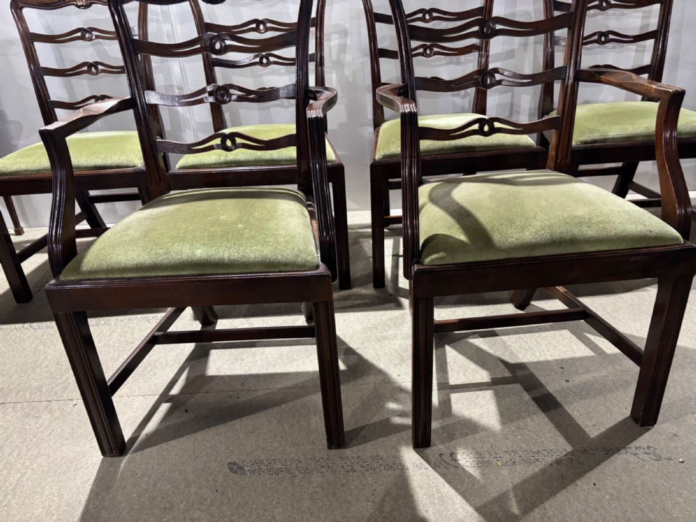 A set of six dark mahogany ladderback dining chairs, including two carvers and four side chairs, featuring serpentine carved splats and green velvet seats. View V