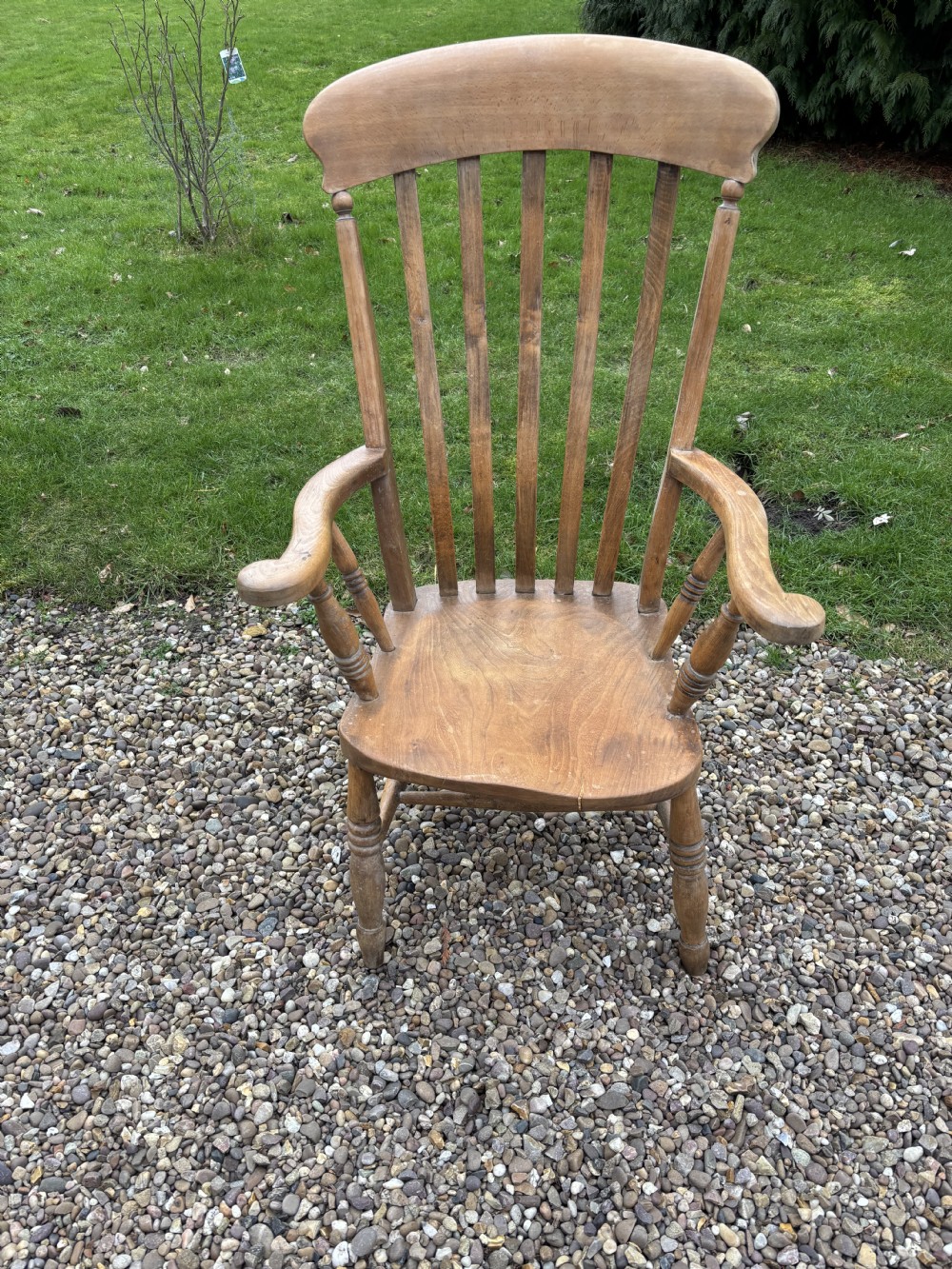 A Victorian ash and elm lath back armchair featuring vertical back slats, shaped armrests, a solid saddle seat, and turned wooden legs. View IV