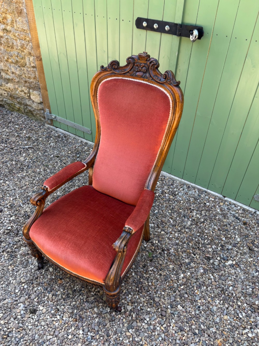 Victorian carved oak armchair featuring a high back upholstered in terracotta velvet with open arms and carved legs. View II