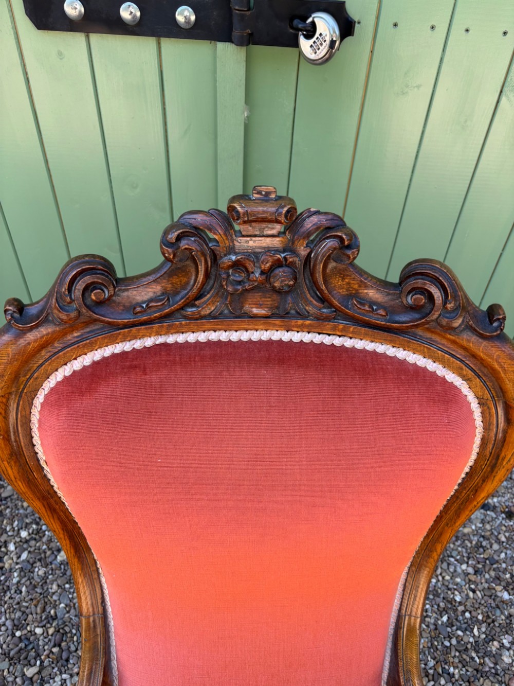 Victorian carved oak armchair featuring a high back upholstered in terracotta velvet with open arms and carved legs. View III