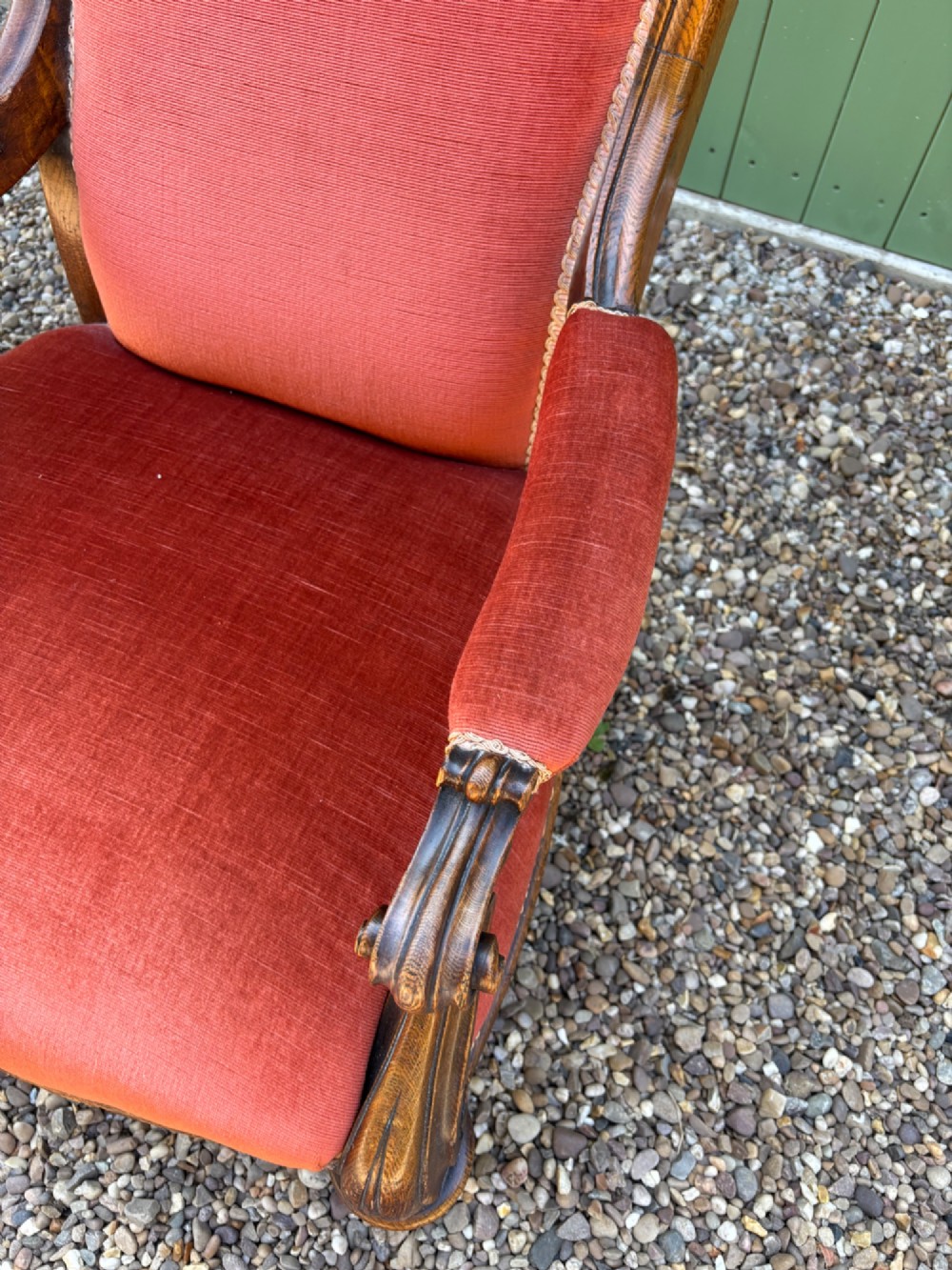 Victorian carved oak armchair featuring a high back upholstered in terracotta velvet with open arms and carved legs. View V