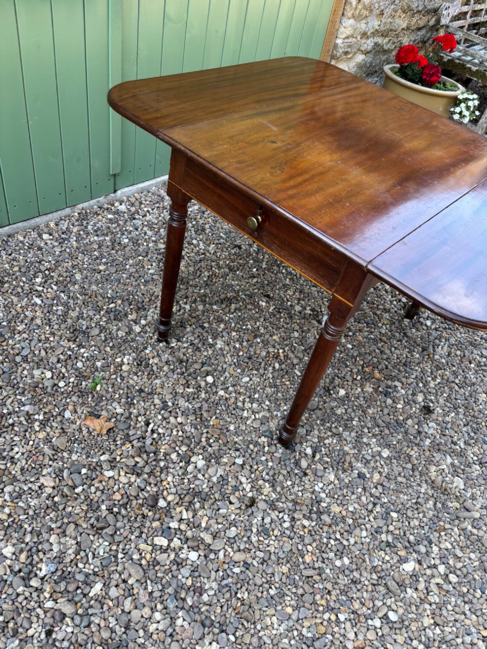 A Victorian mahogany Pembroke table with extended drop leaves and turned wood legs. View II
