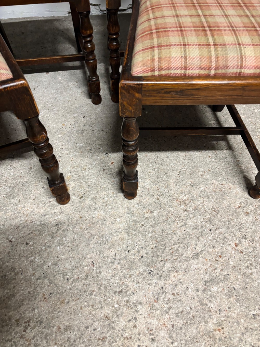 A set of six dark oak dining chairs with cane-panelled backs, barley twist uprights, turned legs, and plaid fabric upholstered seats. View VI