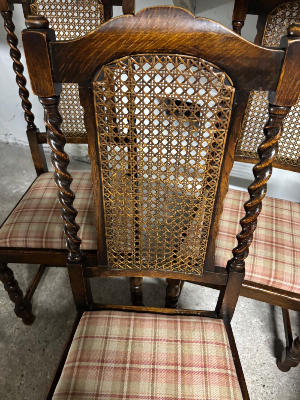 A set of six dark oak dining chairs with cane-panelled backs, barley twist uprights, turned legs, and plaid fabric upholstered seats. View VIII