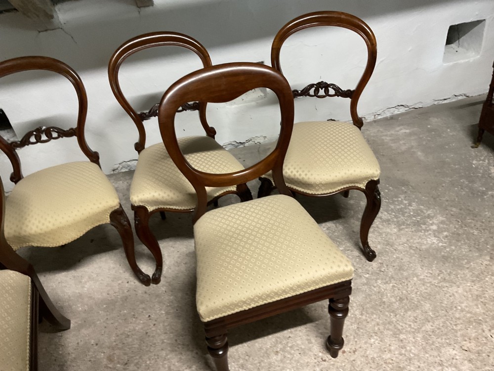 A set of six Victorian balloon back dining chairs in dark wood with cream patterned upholstered seats. View III