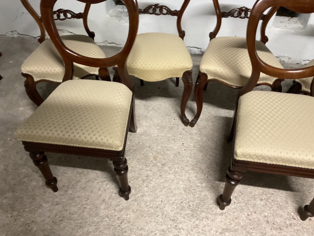 A set of six Victorian balloon back dining chairs in dark wood with cream patterned upholstered seats. View IV