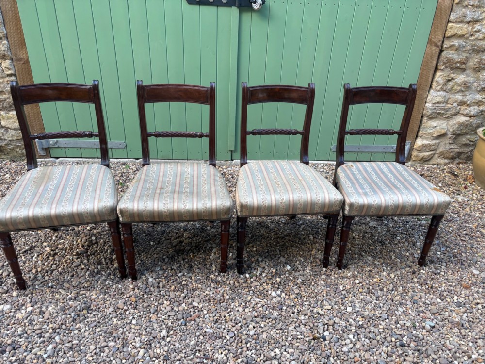 A set of four Regency mahogany dining chairs featuring rope-twist middle rails, turned front legs, and striped fabric seat cushions. View II