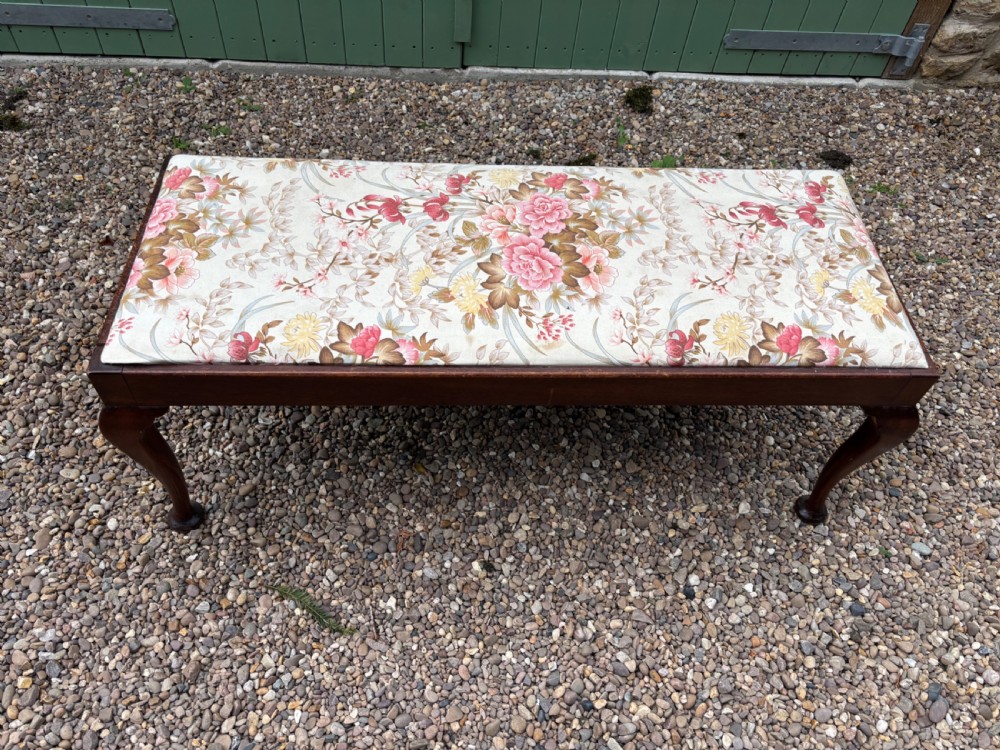 A George III mahogany duet stool featuring a floral upholstered rectangular top and cabriole legs ending in pad feet. View II