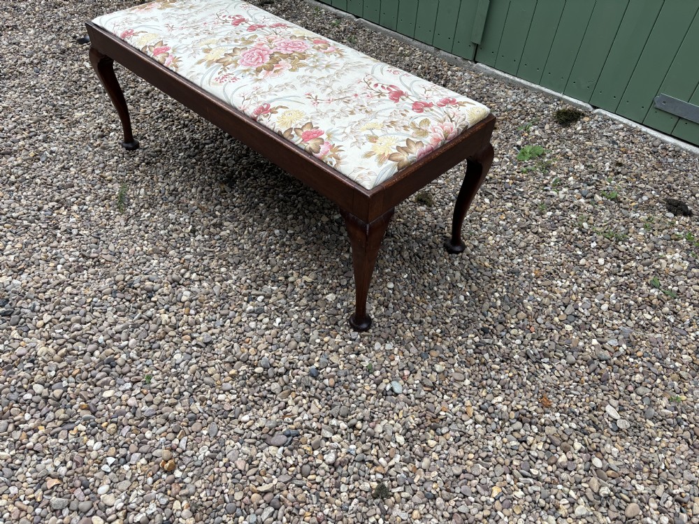A George III mahogany duet stool featuring a floral upholstered rectangular top and cabriole legs ending in pad feet. View III