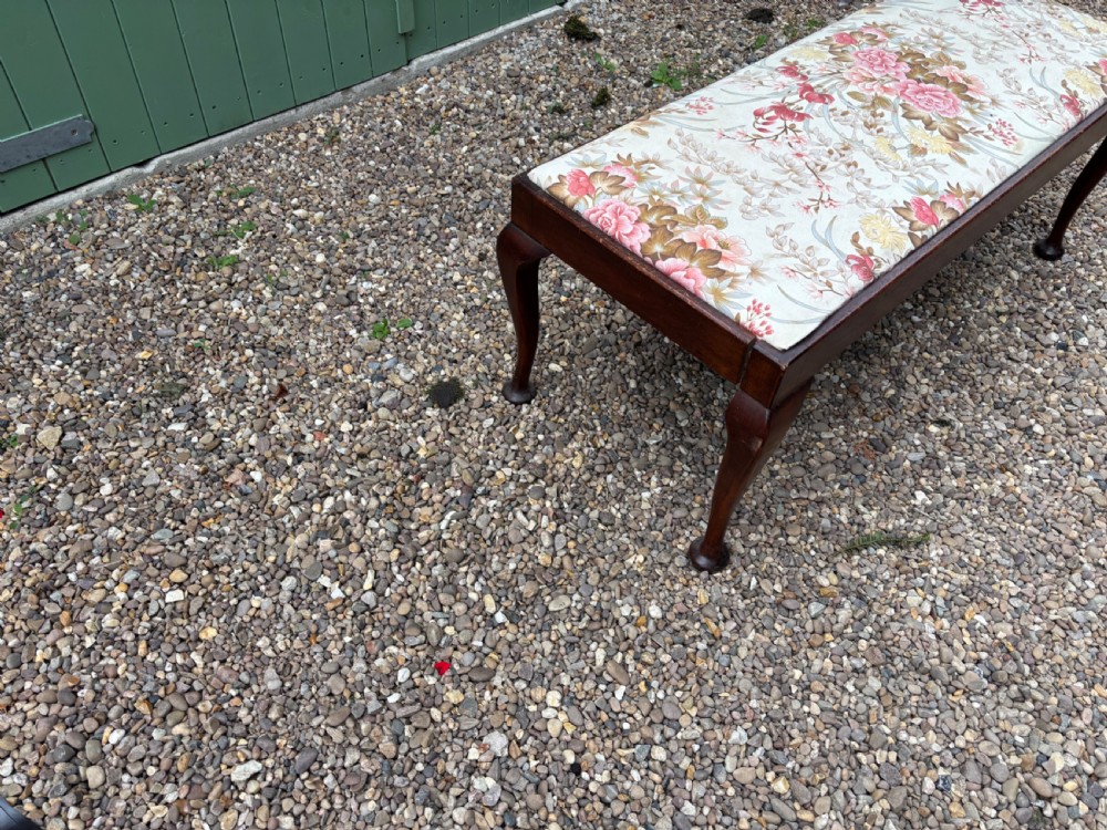 A George III mahogany duet stool featuring a floral upholstered rectangular top and cabriole legs ending in pad feet. View IV