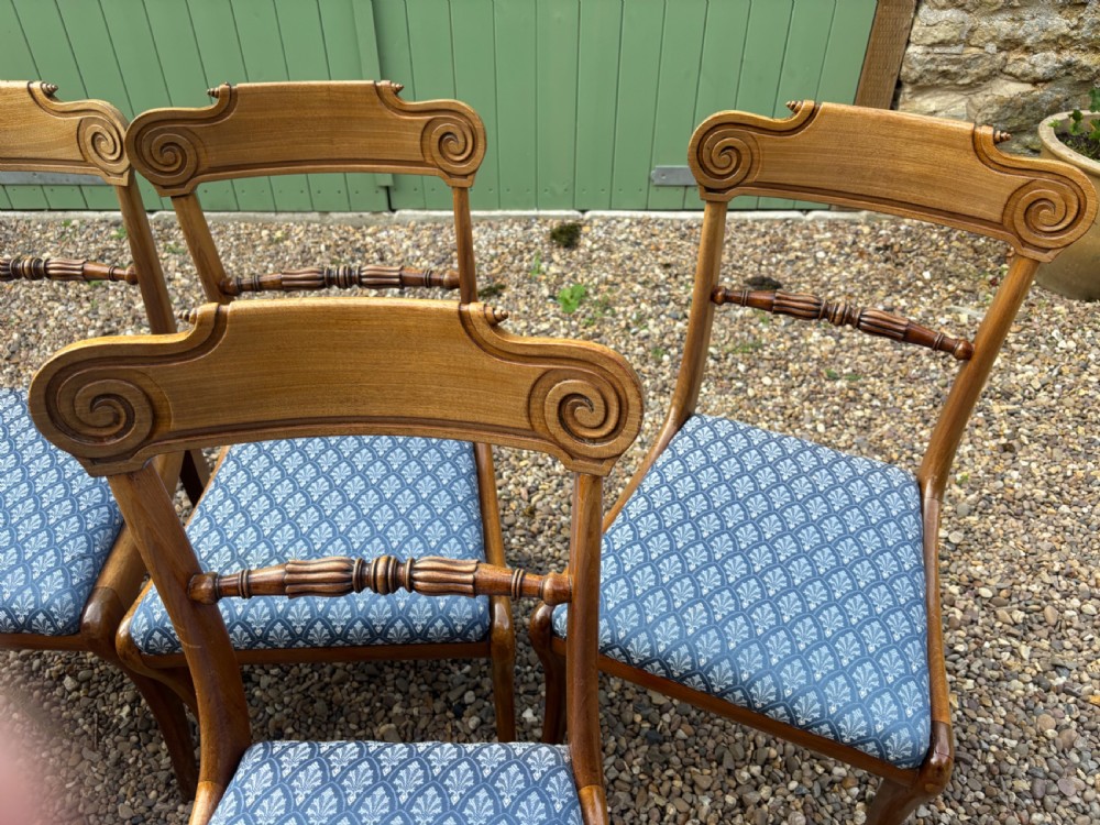 A set of six Regency mahogany dining chairs featuring scrolled top rails, turned horizontal crossbars, and blue patterned upholstered seats. View II