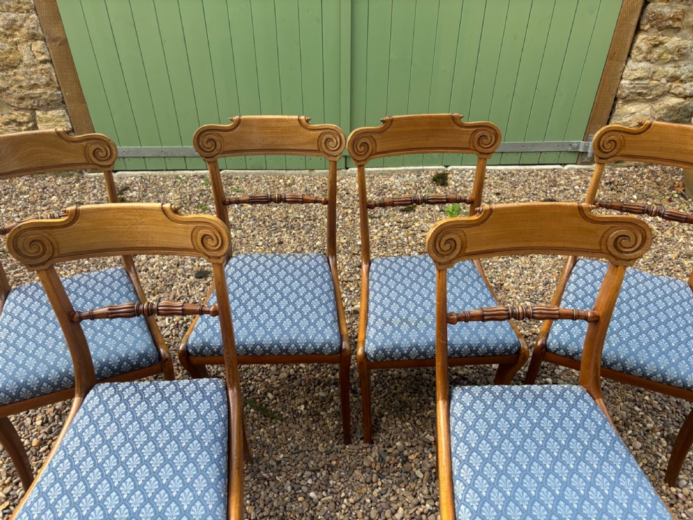 A set of six Regency mahogany dining chairs featuring scrolled top rails, turned horizontal crossbars, and blue patterned upholstered seats. View IV