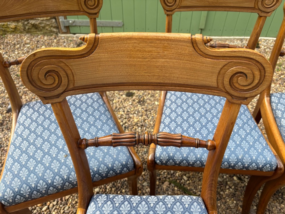 A set of six Regency mahogany dining chairs featuring scrolled top rails, turned horizontal crossbars, and blue patterned upholstered seats. View VII