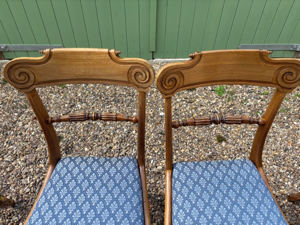 A set of six Regency mahogany dining chairs featuring scrolled top rails, turned horizontal crossbars, and blue patterned upholstered seats. View VIII