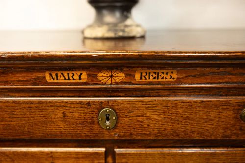 fig 1. An unusual George III oak chest of drawers with the name