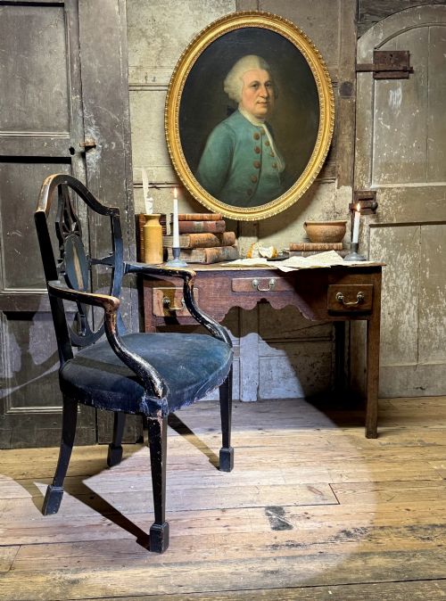 fig 2. An 18th-century oval oil portrait depicting a gentleman in a blue coat and wig, set inside a carved giltwood frame.