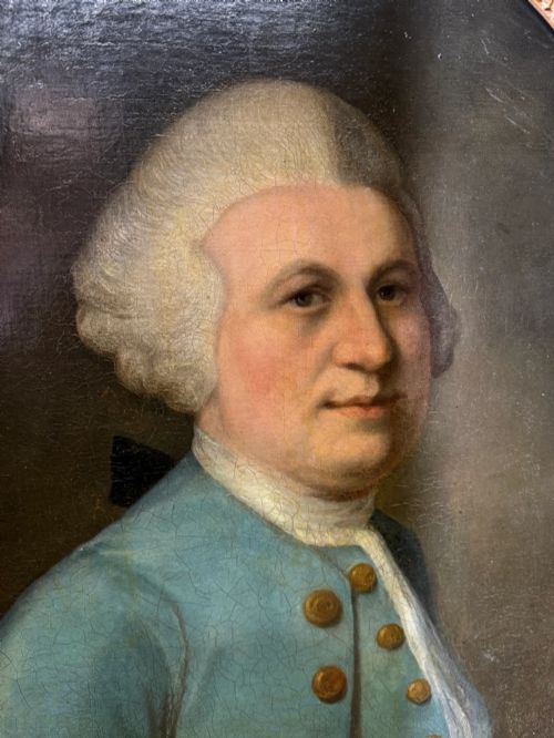 fig 6. An 18th-century oval oil portrait depicting a gentleman in a blue coat and wig, set inside a carved giltwood frame.