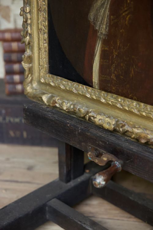 fig 2. An early 18th-century oil portrait depicting a gentleman in a crimson coat and powdered wig, set within a heavily carved gilded frame.