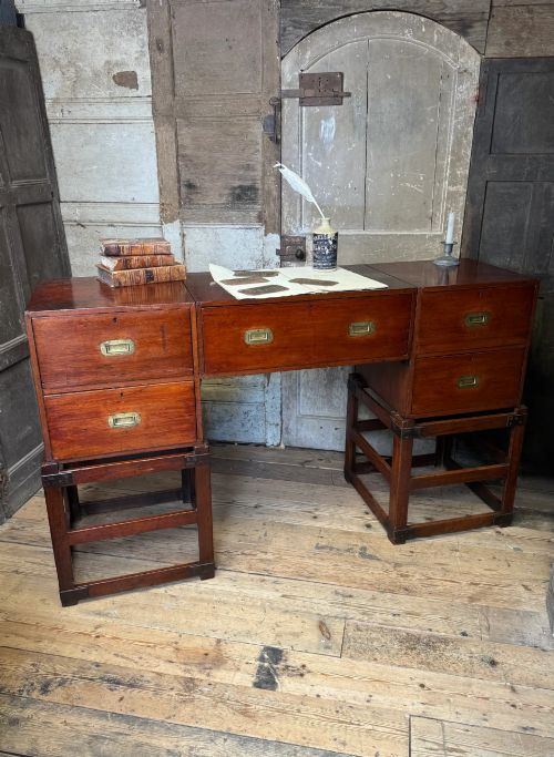 fig 1. Late 19th-century Anglo-Indian campaign desk crafted from rich reddish-brown timber with flush brass handles and open frame bases.