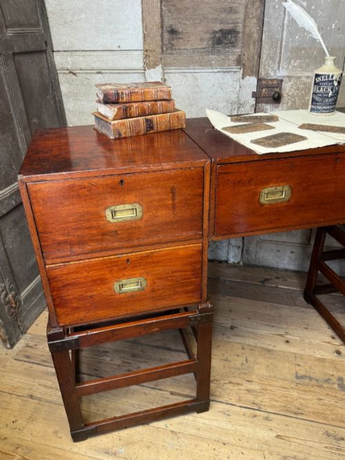 fig 3. Late 19th-century Anglo-Indian campaign desk crafted from rich reddish-brown timber with flush brass handles and open frame bases.