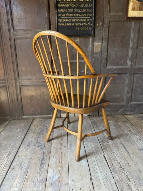 A George III West Country Windsor armchair made of elm and ash wood, featuring a spindled backrest, shaped timber seat, turned legs, and a cow-horn stretcher. View VII