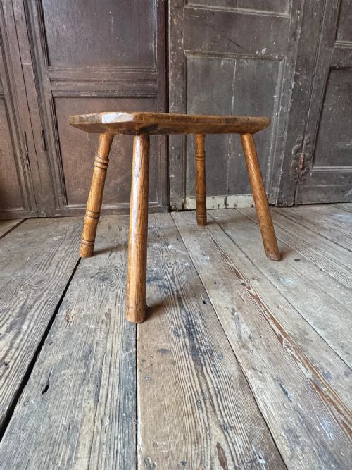 An early 19th-century rustic wooden stool featuring a rectangular sycamore seat top with visible wedged through-tenons and four splayed ash legs. View XI