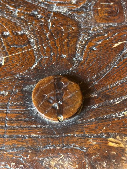 A 19th-century rustic three-legged wooden stool featuring a thick dished circular elm seat and splayed turned legs. View VI