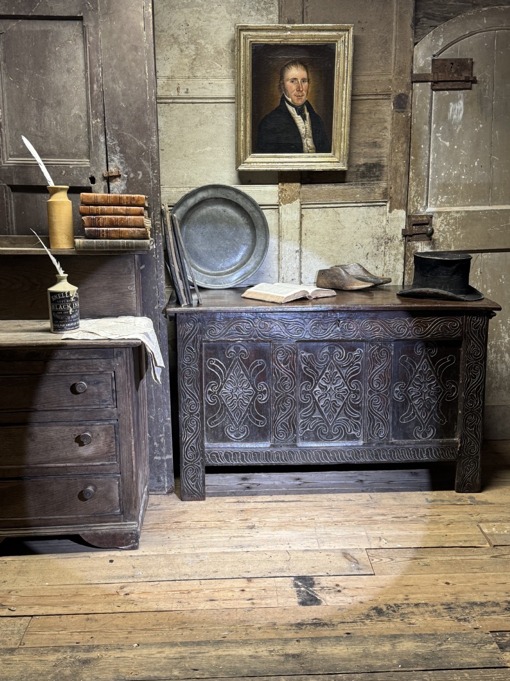 A 17th-century joined oak coffer featuring three carved lozenge panels and decorative carved stiles. View III