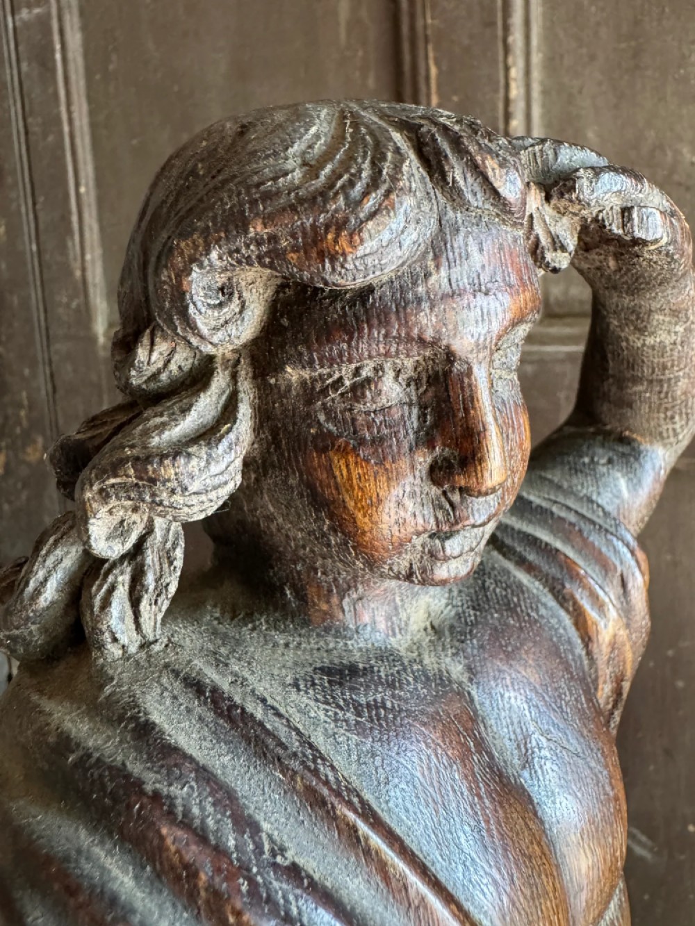 An 18th-century carved oak standing male figure with drapery across his shoulder set on a rounded base. View VIII