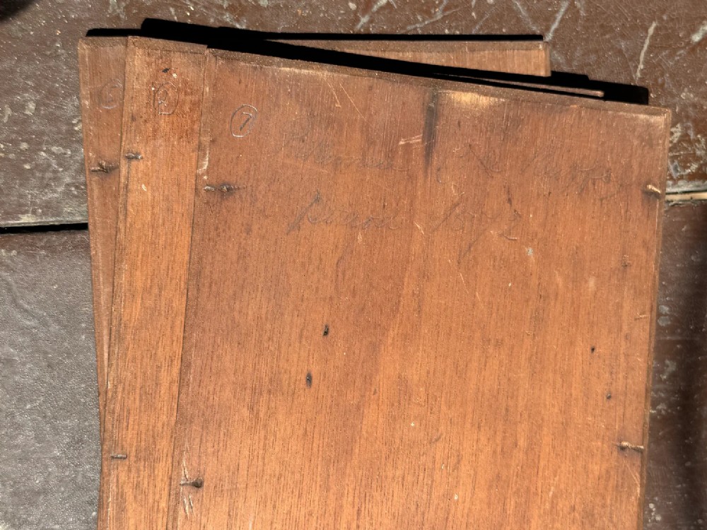 A set of four early twentieth-century wooden panels featuring hand-painted depictions of military soldiers in red uniform coats. View VIII