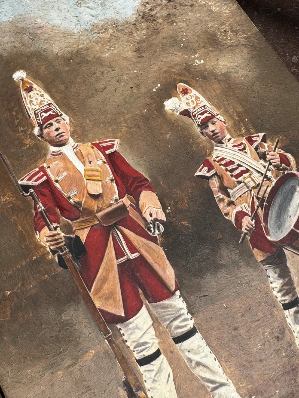 A set of four early twentieth-century wooden panels featuring hand-painted depictions of military soldiers in red uniform coats. View IX