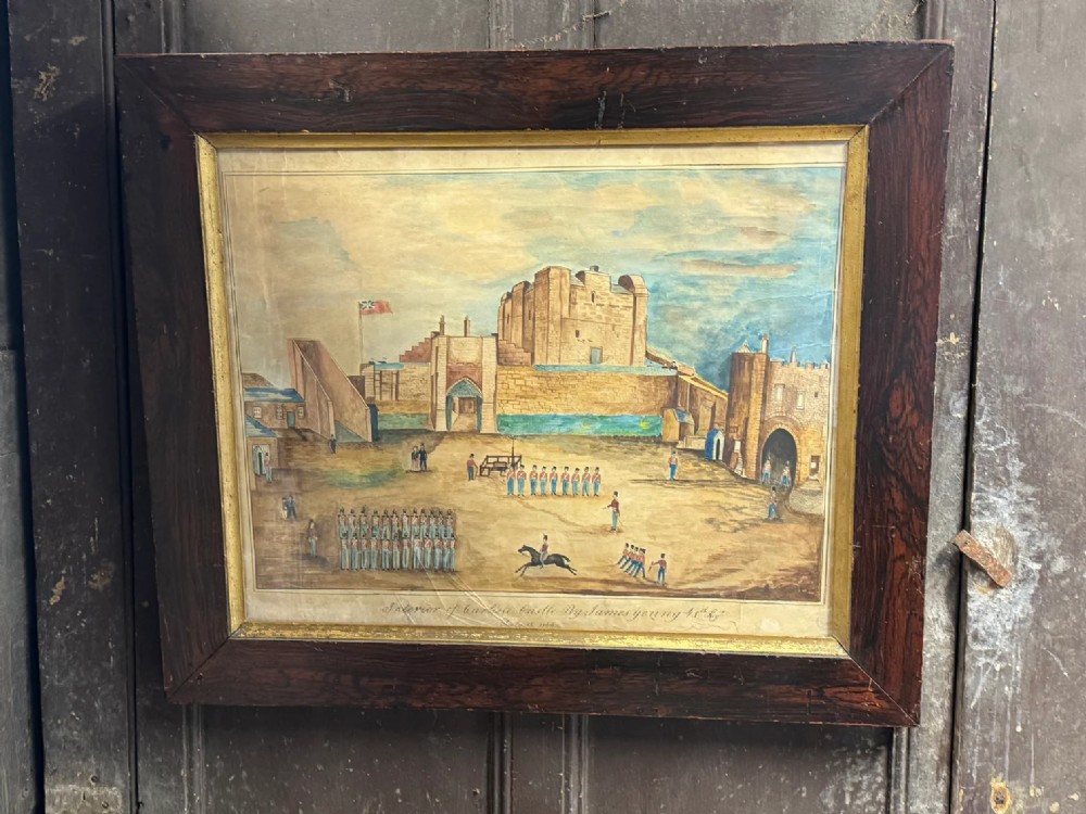 An antique framed watercolour painting depicting soldiers assembled in a castle courtyard within a wide dark wooden frame.