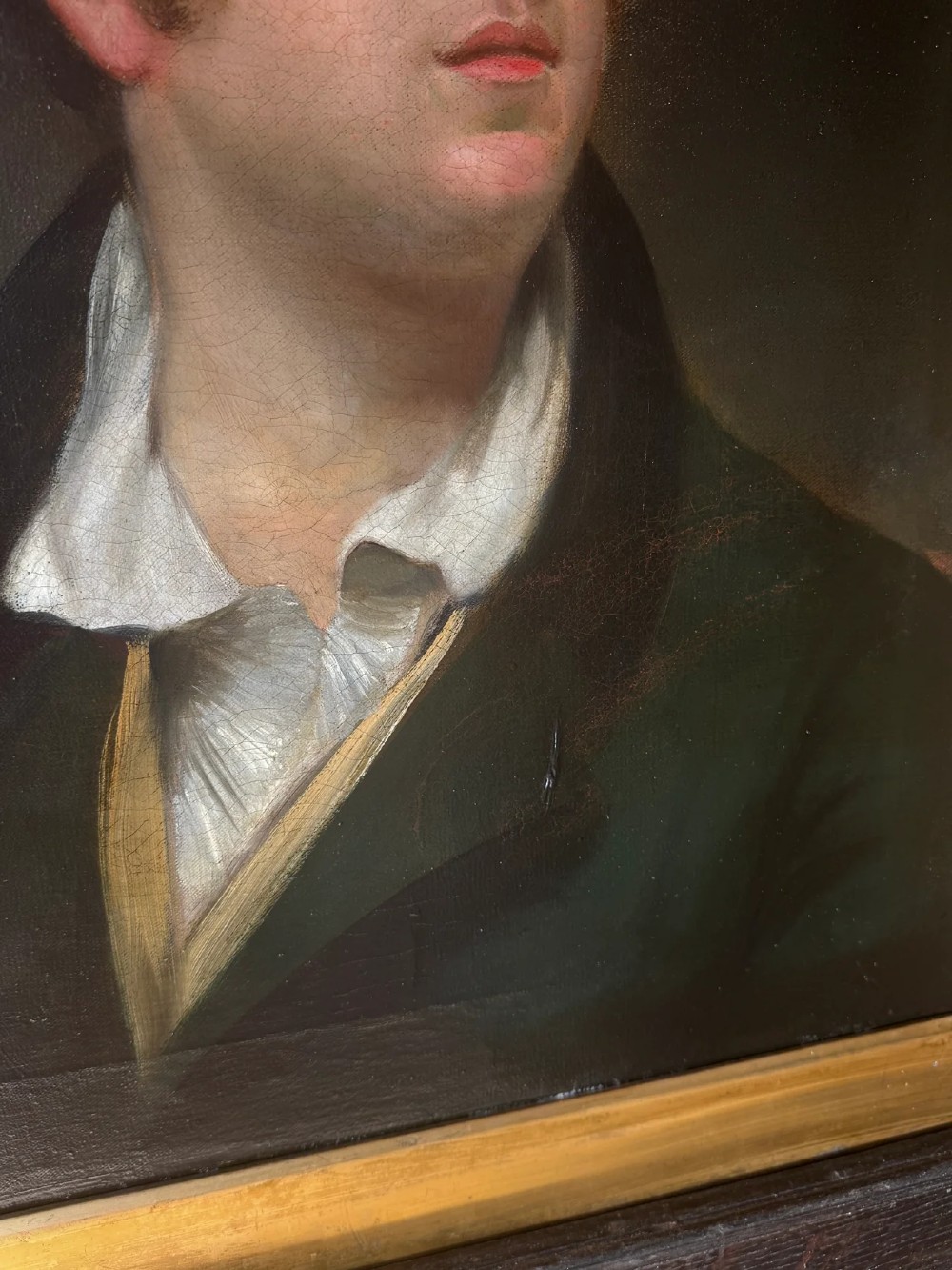 An early 19th-century oil portrait depicting a fair-skinned gentleman with reddish hair in a dark green coat, set inside a gilded wooden frame. View III