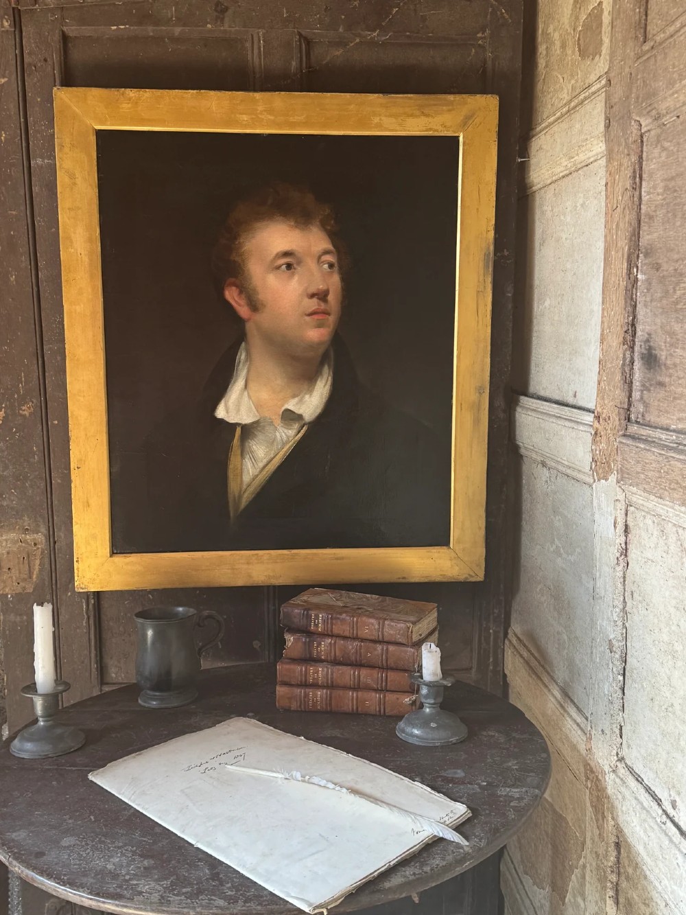 An early 19th-century oil portrait depicting a fair-skinned gentleman with reddish hair in a dark green coat, set inside a gilded wooden frame. View VIII