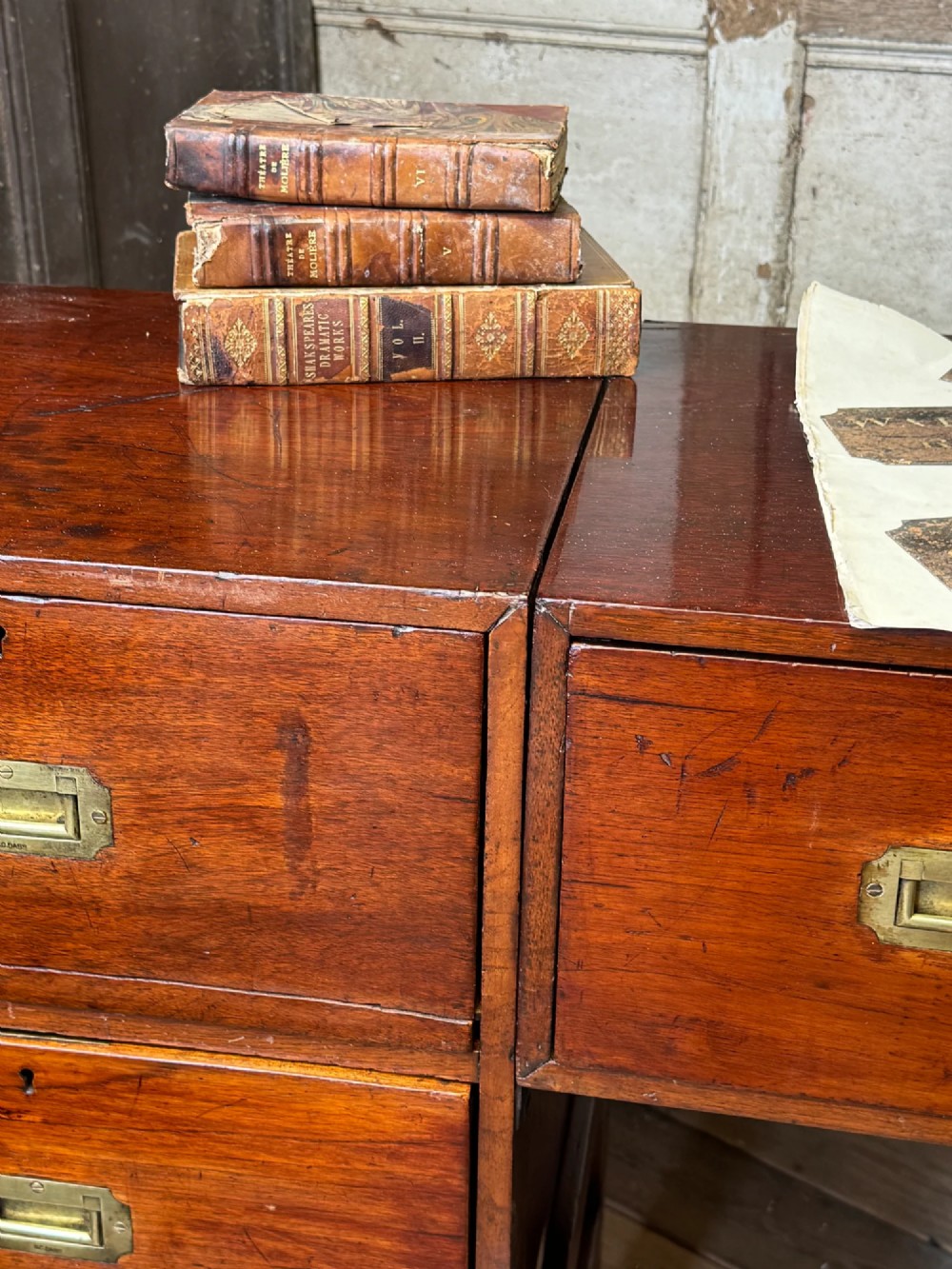 Late 19th-century Anglo-Indian campaign desk crafted from rich reddish-brown timber with flush brass handles and open frame bases. View III