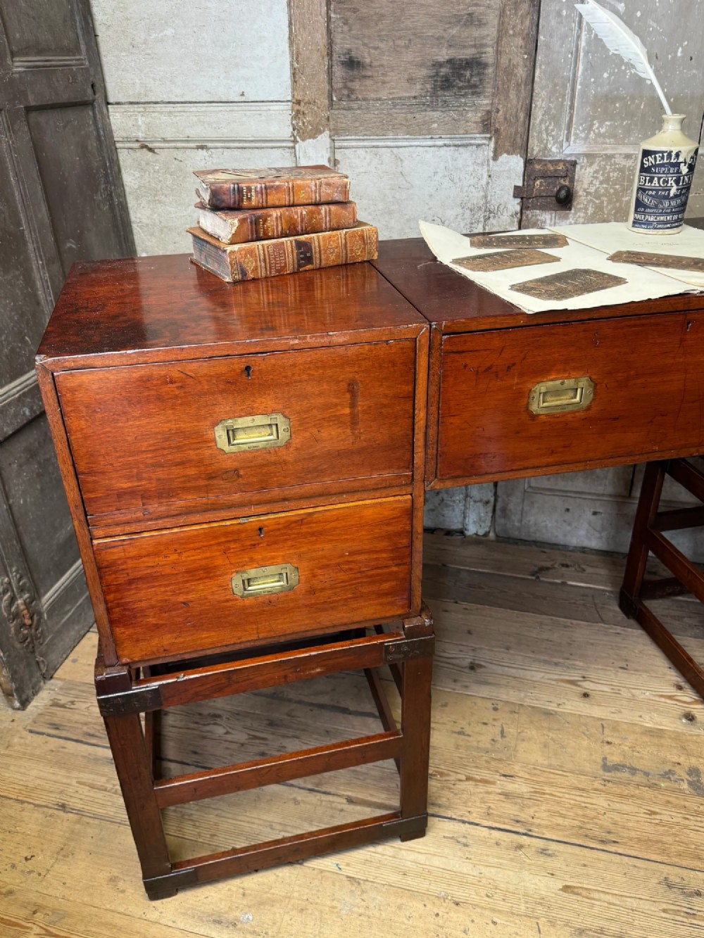 Late 19th-century Anglo-Indian campaign desk crafted from rich reddish-brown timber with flush brass handles and open frame bases. View IV