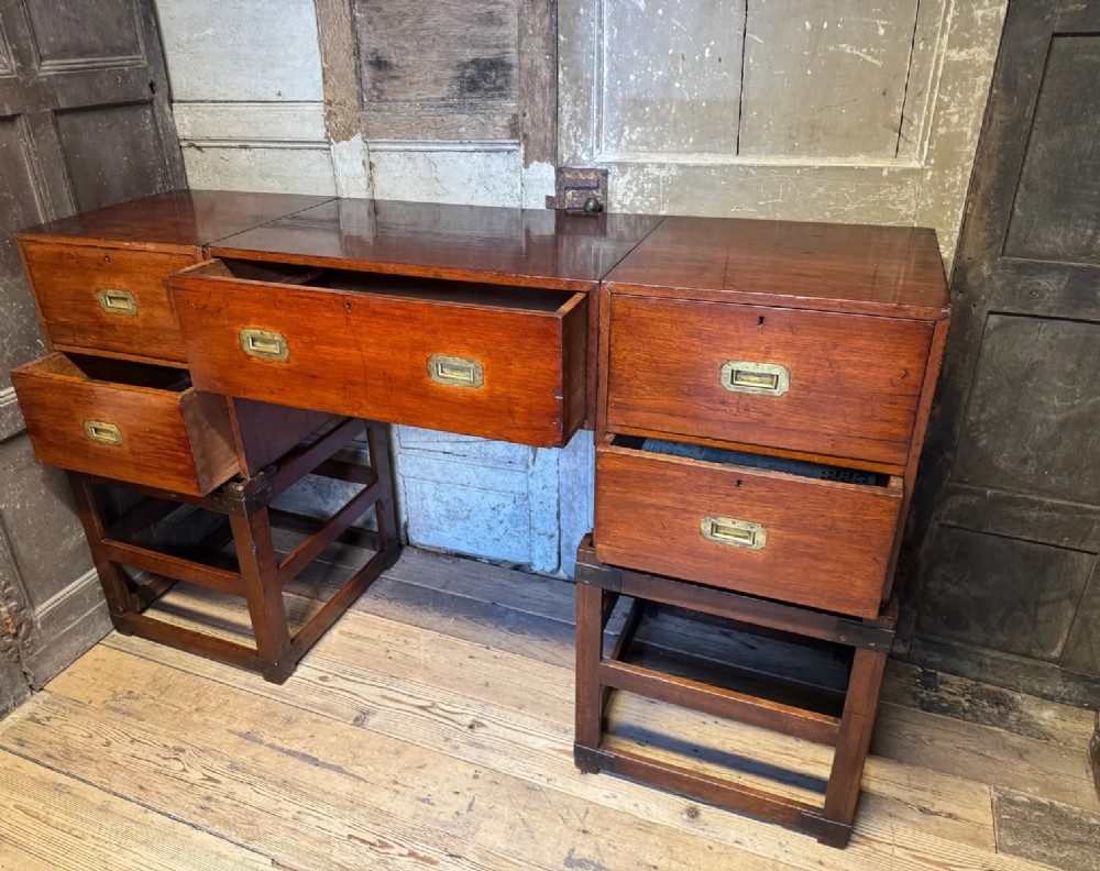 Late 19th-century Anglo-Indian campaign desk crafted from rich reddish-brown timber with flush brass handles and open frame bases. View V