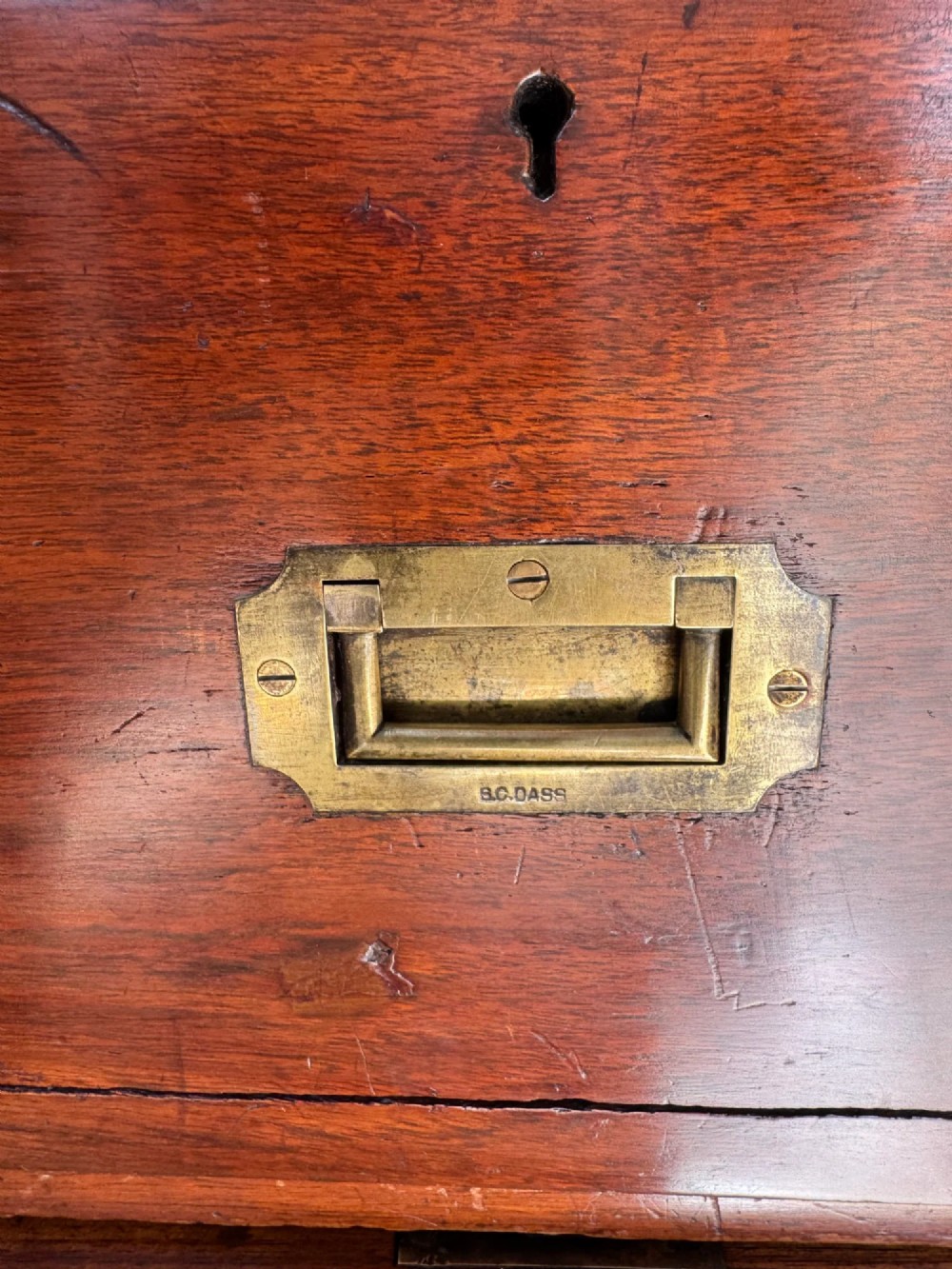 Late 19th-century Anglo-Indian campaign desk crafted from rich reddish-brown timber with flush brass handles and open frame bases. View IX