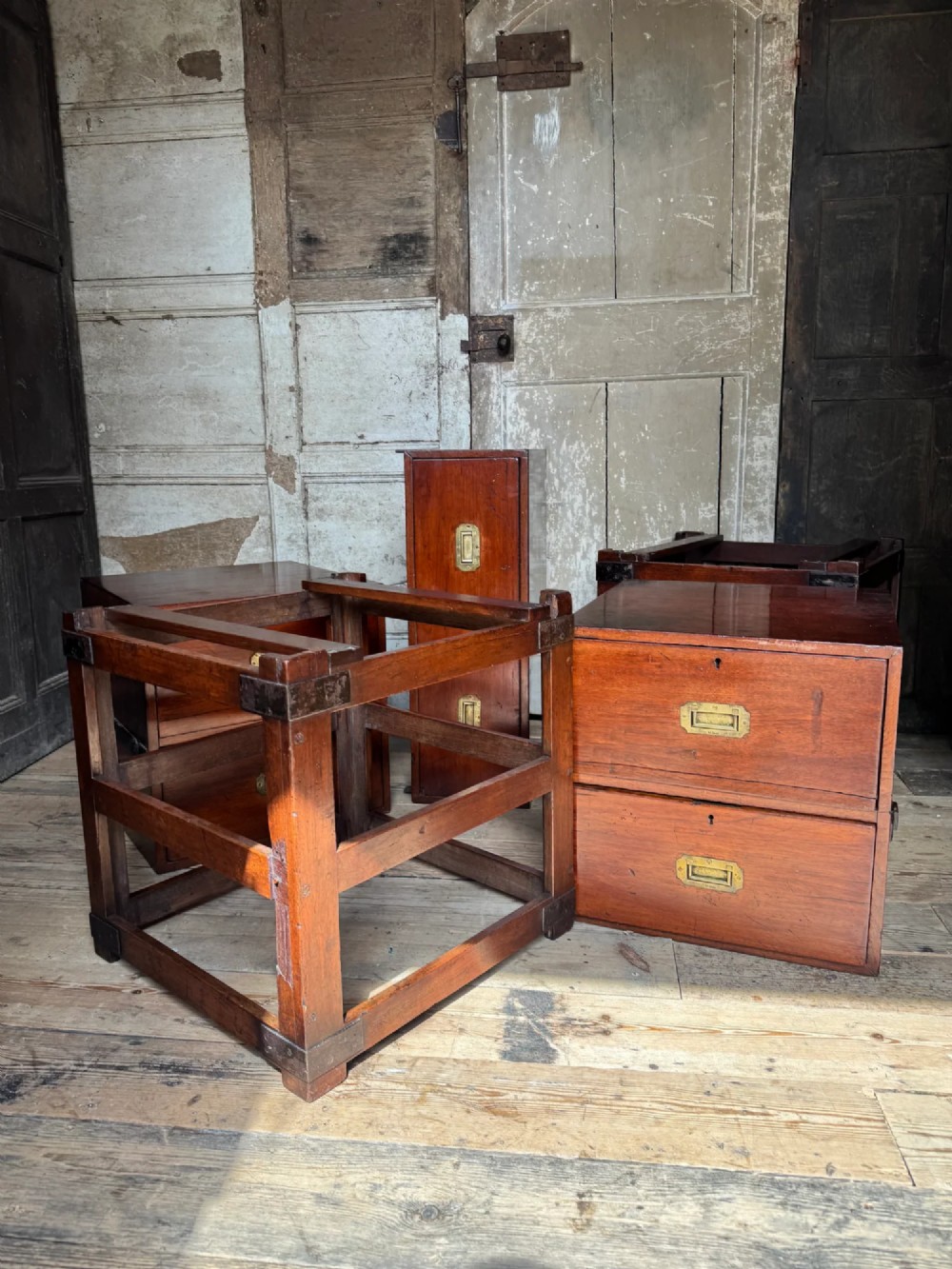 Late 19th-century Anglo-Indian campaign desk crafted from rich reddish-brown timber with flush brass handles and open frame bases. View XI