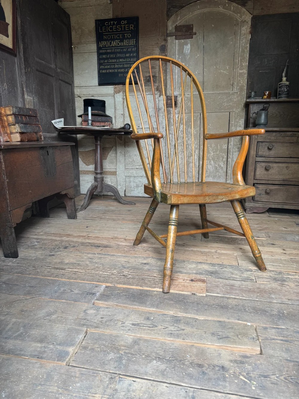 A George III high hoop-back Windsor armchair crafted from elm and ash with turned legs and a carved timber seat. View VII