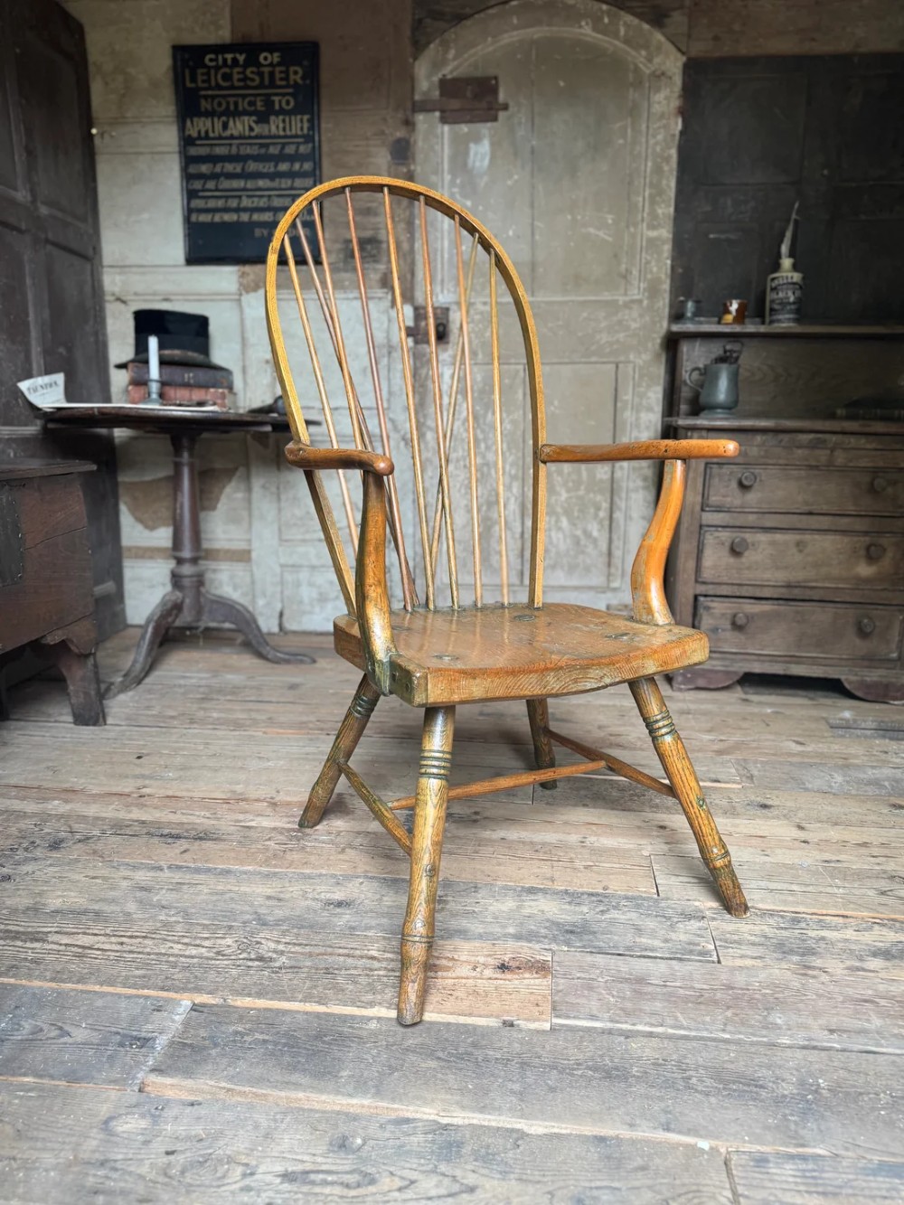 A George III high hoop-back Windsor armchair crafted from elm and ash with turned legs and a carved timber seat. View VIII