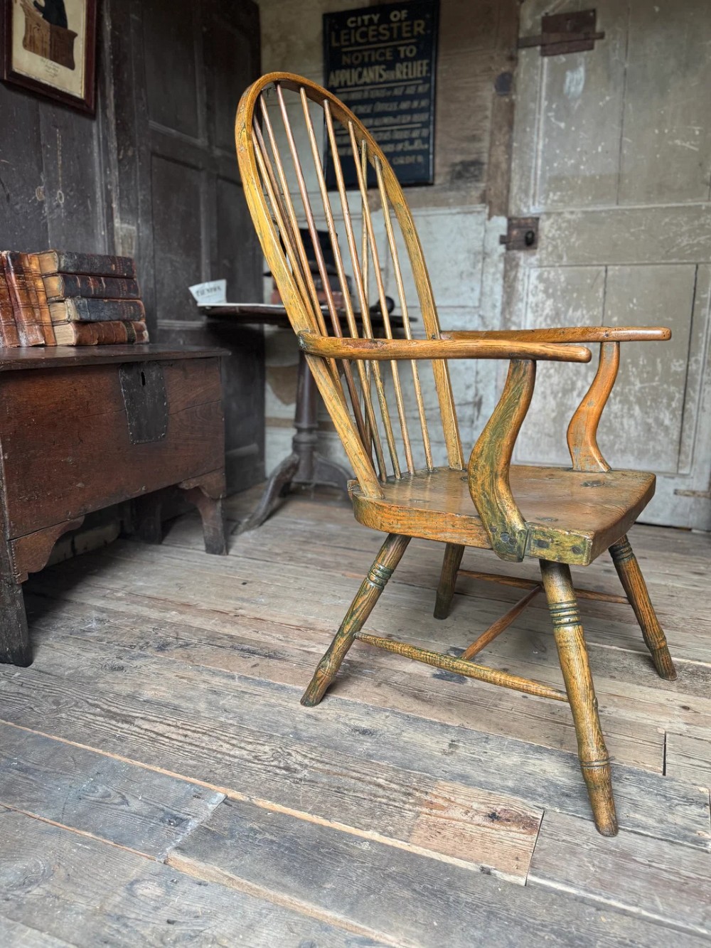 A George III high hoop-back Windsor armchair crafted from elm and ash with turned legs and a carved timber seat. View IX