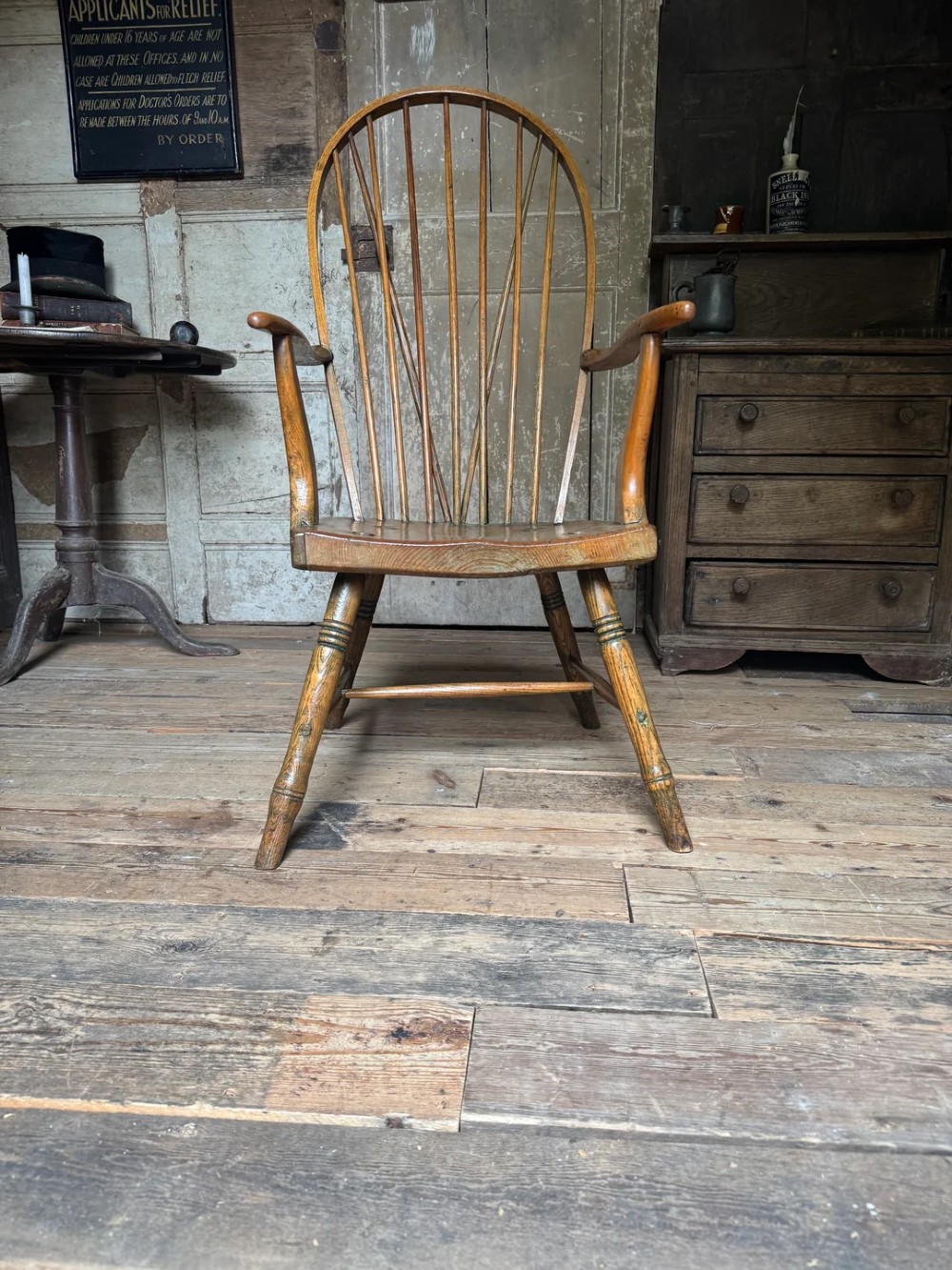 A George III high hoop-back Windsor armchair crafted from elm and ash with turned legs and a carved timber seat. View X