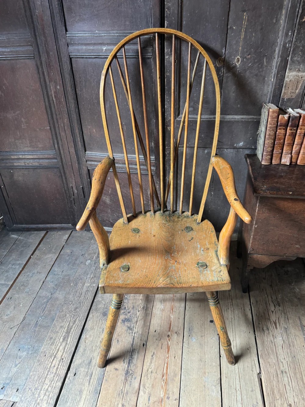 A George III high hoop-back Windsor armchair crafted from elm and ash with turned legs and a carved timber seat. View XII