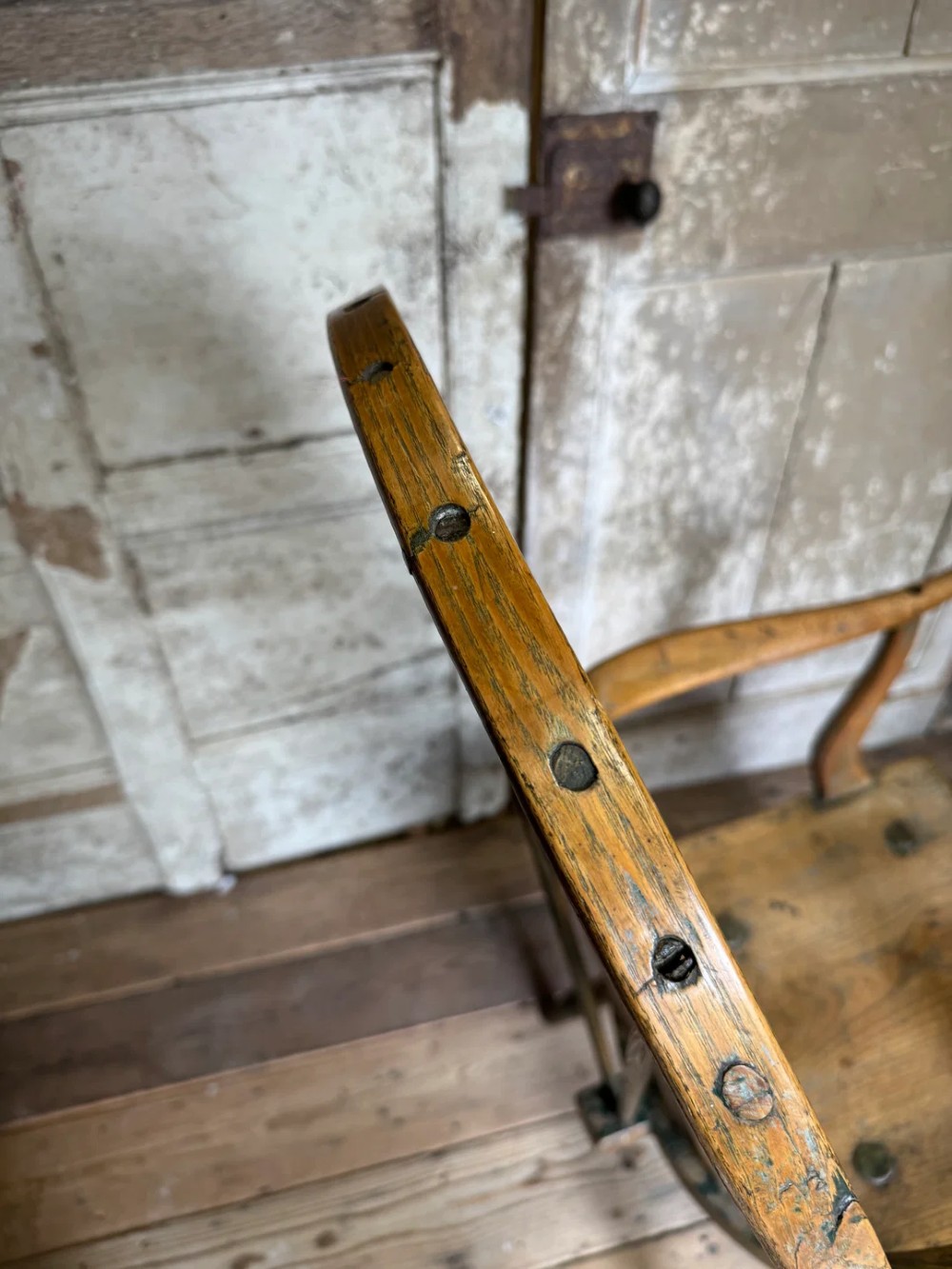 A George III high hoop-back Windsor armchair crafted from elm and ash with turned legs and a carved timber seat. View XIII