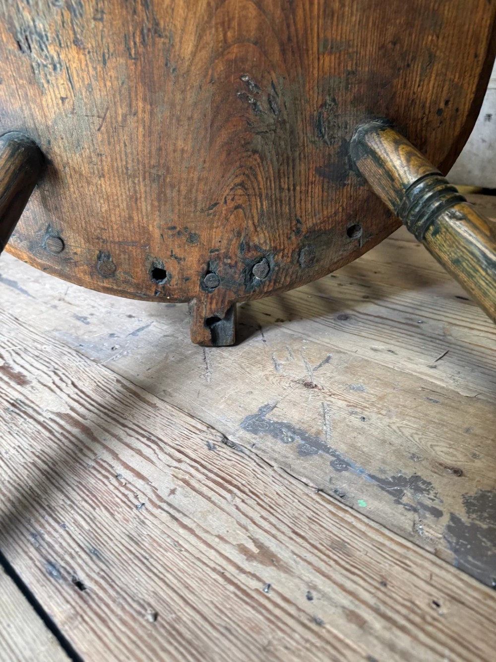 A George III high hoop-back Windsor armchair crafted from elm and ash with turned legs and a carved timber seat. View XIV