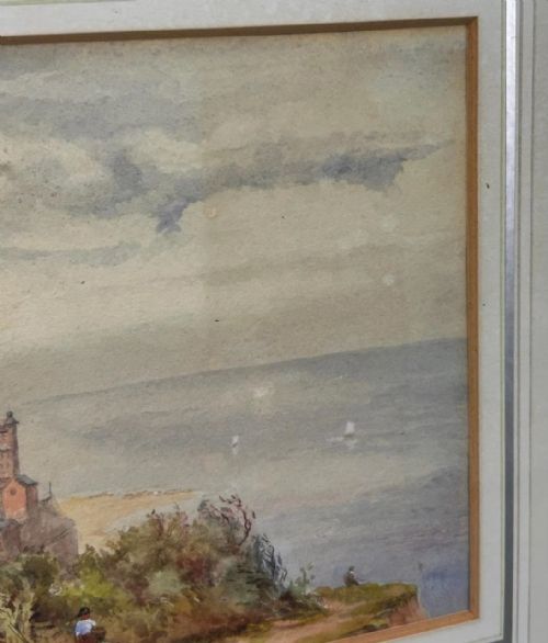 fig 2. A 19th-century watercolour landscape illustrating a coastal town with a church tower, red-roofed buildings, a grassy cliff path, and a serene sea view.