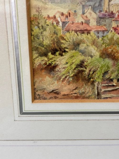 fig 4. A 19th-century watercolour landscape illustrating a coastal town with a church tower, red-roofed buildings, a grassy cliff path, and a serene sea view.